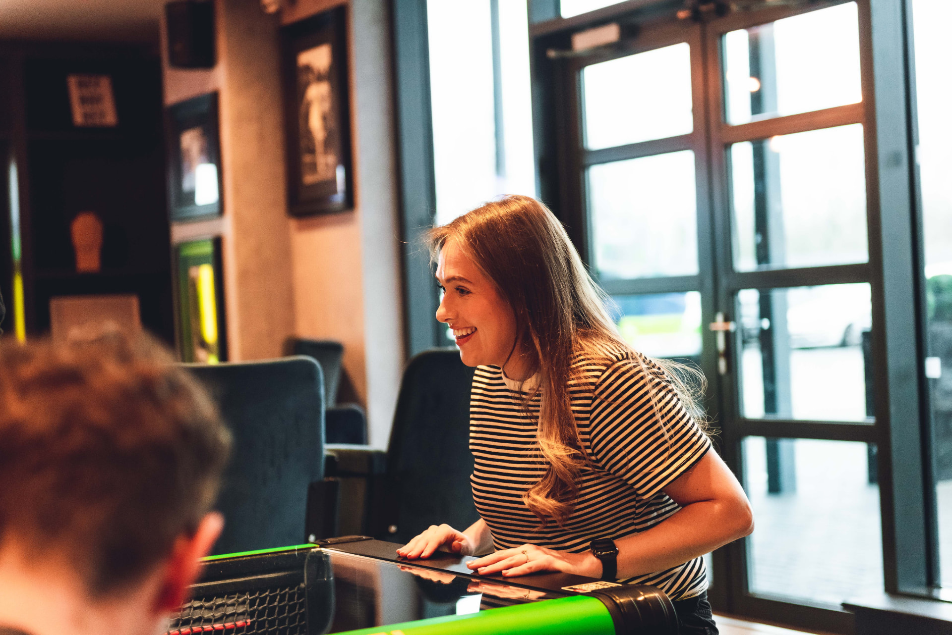 A player laughing across the table mid-match
